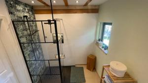 a bathroom with a shower with a glass door at Stilvolle Landidylle in der Südheide in Wittingen +31 photos