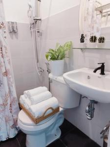 a bathroom with a toilet and a sink at De Richness in Tagbilaran City +14 photos