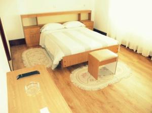 a bedroom with a bed and a wooden floor at Room das Lindos in Mondim de Basto