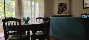 a dining room table with two chairs and a window at Room das Lindos in Mondim de Basto