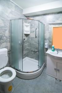 een badkamer met een douche, een toilet en een wastafel bij Hostel Bordada in Kraljevica