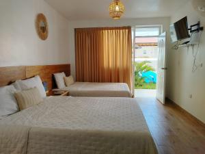 Postel nebo postele na pokoji v ubytování Prim Hotel Vichayito