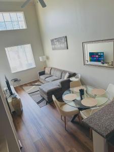 a living room with a couch and a table and chairs at Loft Style,2 Beds ,Flexible self check in,Pool in Marina del Rey