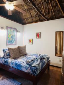 a bed in a room with a ceiling at Hotel Del Rio in San Pedro