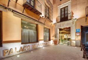 a store front with a sign on the side of a building at Sercotel Palacio de los Gamboa in Granada +43 photos