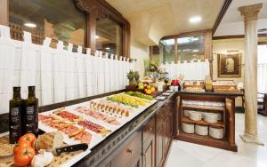 a kitchen with many different types of food on display at Sercotel Palacio de los Gamboa in Granada