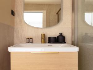 a bathroom with a white sink and a mirror at Charming studio 2P- Montorgueil in Paris