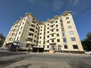 a large building on the side of a street at COMFORT iNN 2 in Samarkand