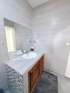a bathroom with a sink and a mirror at Maison villa la faveur in Ngaparou +5 photos