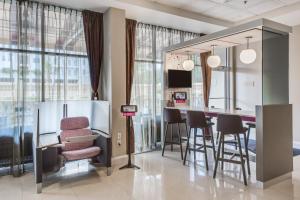 a kitchen with a bar with chairs and a table at Crowne Plaza Orlando-Downtown by IHG in Orlando