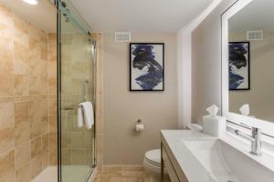 a bathroom with a shower and a sink and a toilet at Crowne Plaza Orlando-Downtown by IHG in Orlando