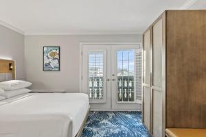 a bedroom with a bed and two windows at Crowne Plaza Orlando-Downtown by IHG in Orlando