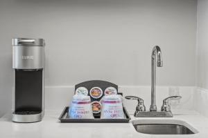 a kitchen counter with a sink and a bottle of milk at Crowne Plaza Orlando-Downtown by IHG in Orlando
