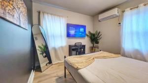 a hospital room with a bed and a tv at Stylish & Cozy #3 8 mins to DCA & Washington DC in Alexandria