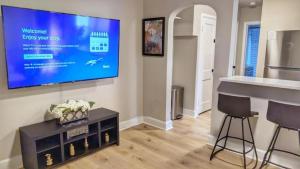 a living room with a flat screen tv on the wall at Stylish & Cozy #3 8 mins to DCA & Washington DC in Alexandria