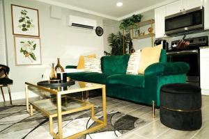 a living room with a green couch and a table at Modern 1BR Unit with Free Parking Walk to Metro in Washington +27 photos