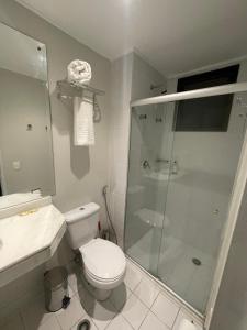 サンパウロにあるQlty Faria Lima Flat Hotel - Your Placeのトイレとガラスのシャワー付きのバスルーム