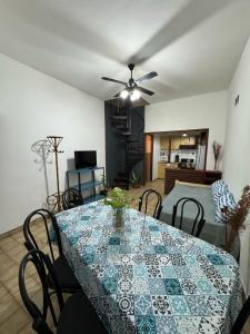 a dining room with a table and a ceiling fan at CasaSansaba in Gerli