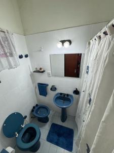 a bathroom with a blue toilet and a sink at CasaSansaba in Gerli