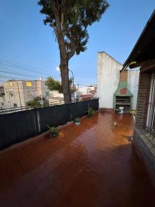 a patio with a tree and a fence at CasaSansaba in Gerli
