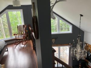 a living room with a chandelier and a dining room at Night Sky Cottage in Saint-Joachim +13 photos