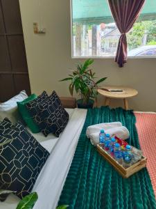 a bed with a tray of water bottles on it at Near Central Festival Hat Yai,5-8 people in Hat Yai