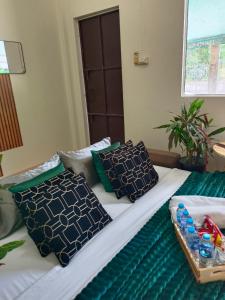 a bed with two pillows and a tray on it at Near Central Festival Hat Yai,5-8 people in Hat Yai