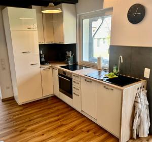 a kitchen with a white refrigerator and a sink at Ferienhaus Königshofen in Königshofen auf der Heide