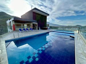 a swimming pool with blue chairs and a house at Nuevo SMART-HOME de Lujo a Playa Rodadero con Piscina Panorámica in Gaira +40 photos
