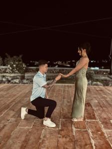 a man and a woman are holding hands at Argo Village in Santorini