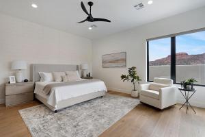 a white bedroom with a bed and a chair at Luxury Desert Oasis in Kanab Near Zion Family in Kanab