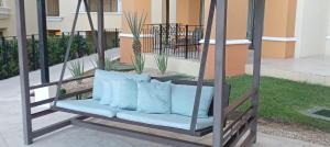 a porch swing with blue pillows on it at Medano Beach suite in Cabo San Lucas