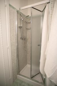 a shower with a glass door in a bathroom at B&B Corte dell' Immacolata in Taviano