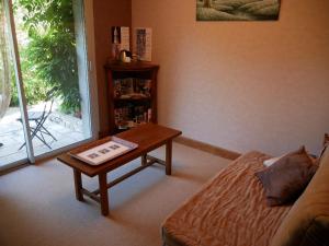 un soggiorno con un tavolino da caffè e un divano di Grande maison calme avec jardin et rivière - FR-1-590-263 a Saint-Martin-dʼAbbat