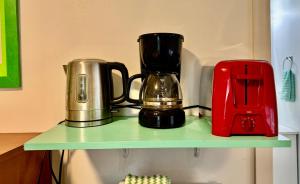 a green shelf with a blender and a toaster on it at Micro Studio Apartment 10 Minutes Walk to University of Washington in Seattle