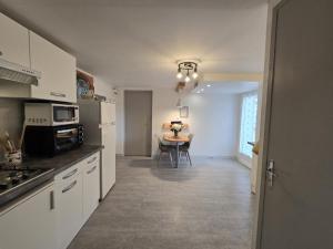 a kitchen with a table and a dining room at Appartement cosy avec terrasse et piscine dans le Périgord Noir - FR-1-616-473 in Saint-Chamassy