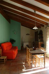 a living room with a table and a couch at Apartamentos Casa Vidal in Adahuesca
