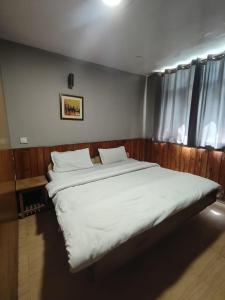 Voodi või voodid majutusasutuse Koyal Lodge toas