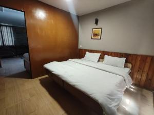 Voodi või voodid majutusasutuse Koyal Lodge toas