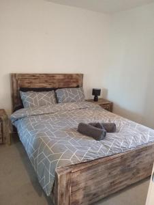 1 dormitorio con 1 cama de madera y 2 almohadas en City views South Melbourne, en Melbourne
