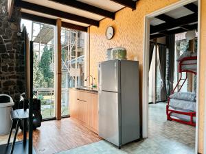 a kitchen with a stainless steel refrigerator in a room at De Villa Istana Bunga Lembang by YourHome in Tegalharendong
