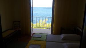 a bedroom with a window with a view of the ocean at Apartment Varga in Sveti Juraj