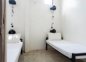 Voodi või voodid majutusasutuse Sip Sunset Hostel and Lounge toas