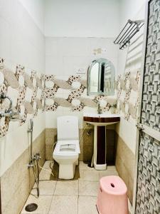 a bathroom with a toilet and a sink and a mirror at Hotel Royal Pinkcity in Jaipur +30 photos