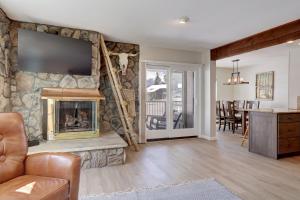 a living room with a stone wall with a fireplace at E101 Lake Cliffe condo in Dillon