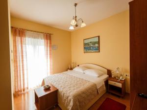 a bedroom with a large bed and a window at Hotel Adria in Kaštela