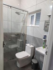 a bathroom with a shower and a toilet and a sink at Uthuppan's Holiday Home in Munnar +42 photos