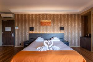 Postel nebo postele na pokoji v ubytování Hotel Donny