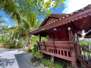 a small house with a bench in front of it at Healing House Holistic Farm Stay in Ban Wet