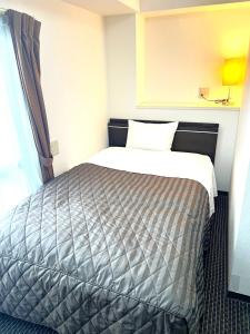 Postel nebo postele na pokoji v ubytování Business Inn Sennichimae Hotel